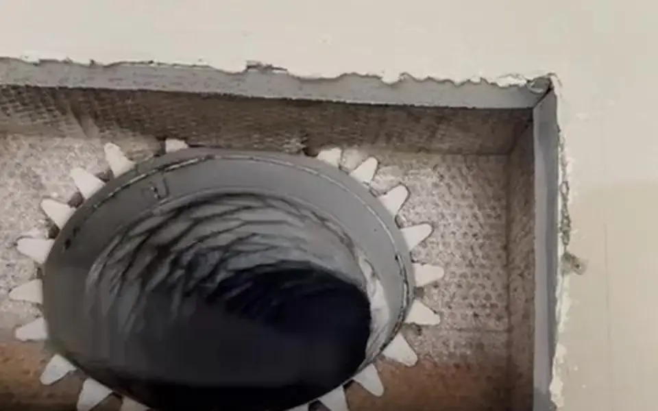Ecovent footage: the rotary brush cable working inside an air duct opened at a ceiling register