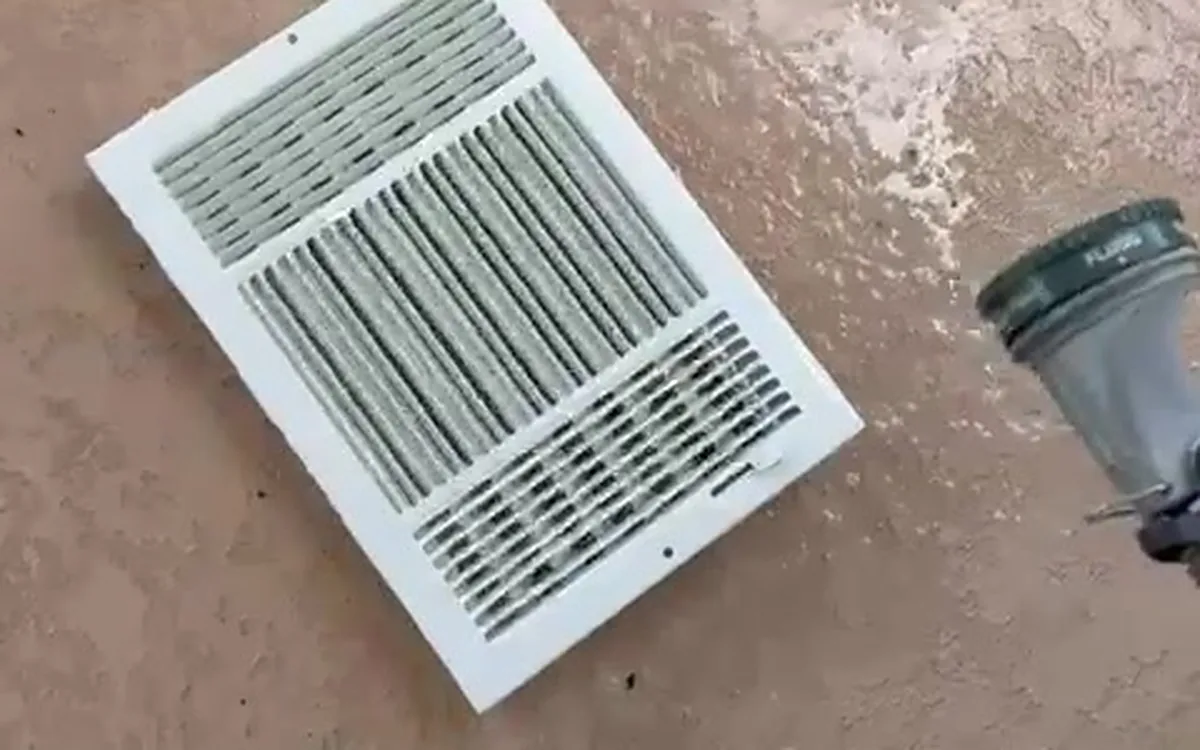 A supply register being washed during an air duct cleaning